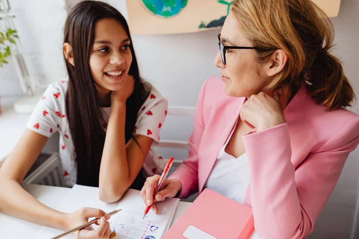 A teacher helping a student with schoolwork