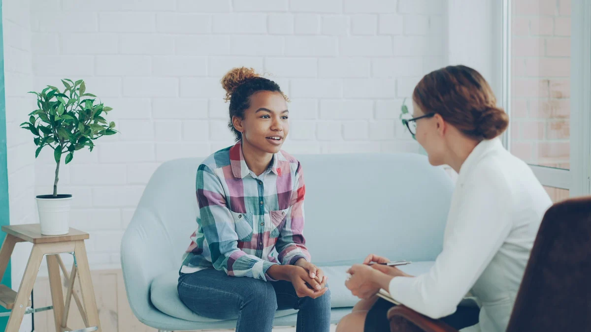 A teenager speaking with a counselor